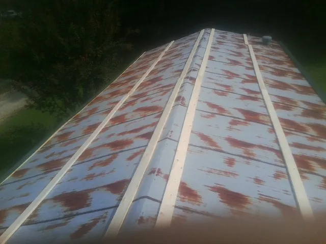 Rusted metal roof panels with new wood purlins before replacement — Storm Damage Roof Repair in Hayward by Roofing Brothers